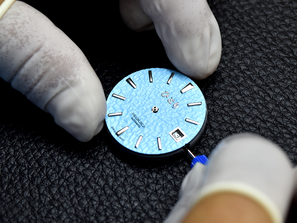 Adjusting the date before placing each hands onto the dial