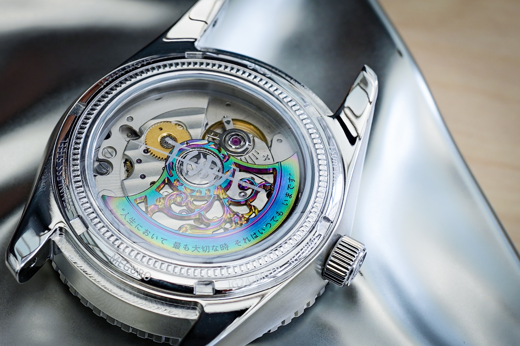 The 'TORA' signed caseback exhibits the winding rotar.